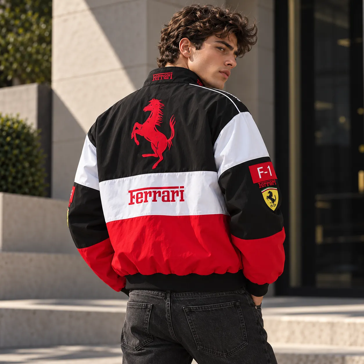 Back view of a man wearing the white, red and black Ferrari racing jacket
